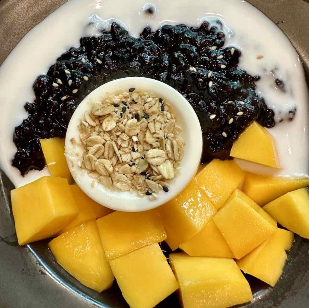 Black Coconut Pudding - Coconut Milk Sauce, Black Sticky Rice and Fresh Mango with Thai Granola, Thailand © PetersTravel Peter Pohle